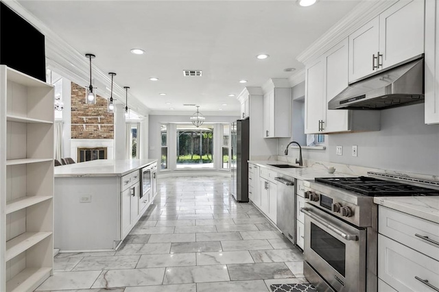 kitchen with crown molding, decorative light fixtures, light stone counters, white cabinetry, and stainless steel appliances