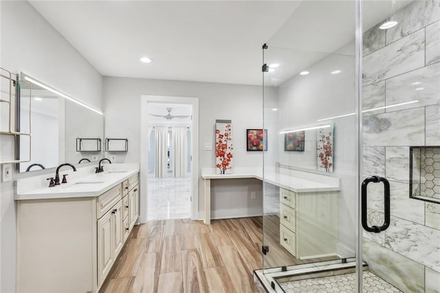 bathroom featuring walk in shower, vanity, hardwood / wood-style flooring, and ceiling fan