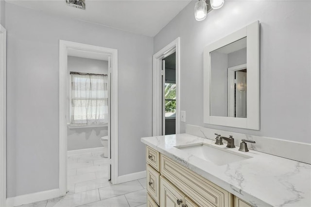 bathroom with vanity and toilet