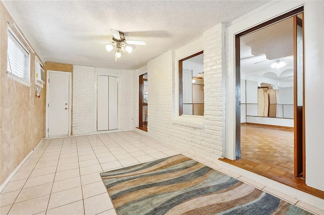 hall with light parquet flooring and a textured ceiling