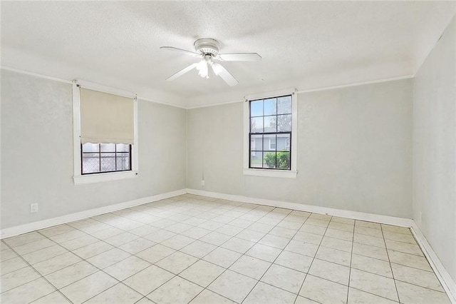 empty room featuring ceiling fan, light tile patterned flooring, and a textured ceiling