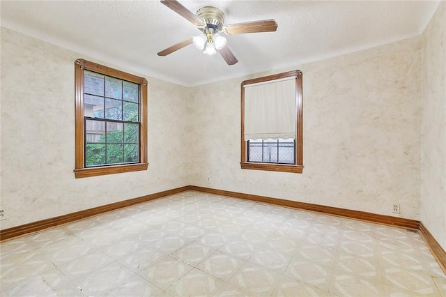 unfurnished room with a textured ceiling and ceiling fan