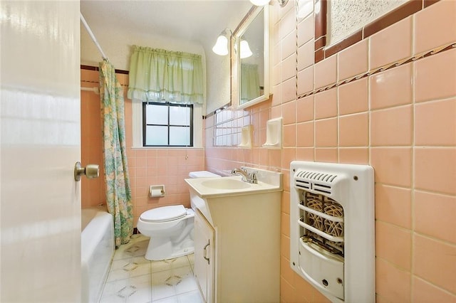 full bathroom featuring tile patterned floors, vanity, heating unit, shower / tub combo with curtain, and tile walls