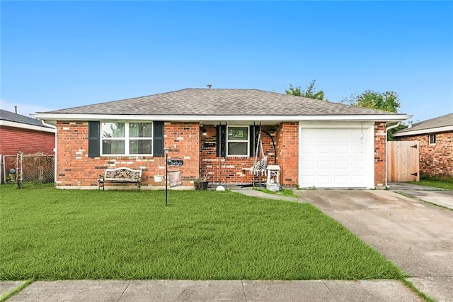 ranch-style home featuring a front lawn and a garage