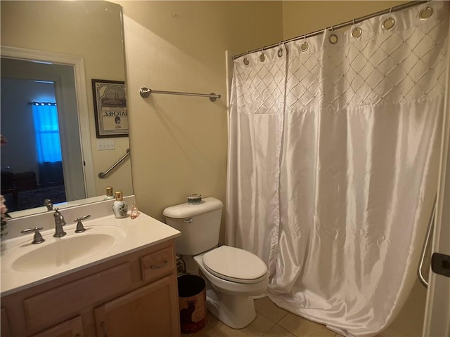 bathroom with tile patterned flooring, vanity, and toilet