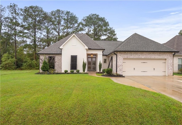 french country style house with french doors, a garage, and a front lawn