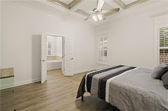 bedroom with beam ceiling, ceiling fan, coffered ceiling, ensuite bathroom, and light wood-type flooring