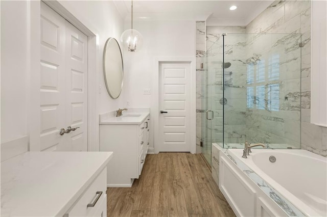 bathroom with vanity, plus walk in shower, ornamental molding, and hardwood / wood-style flooring