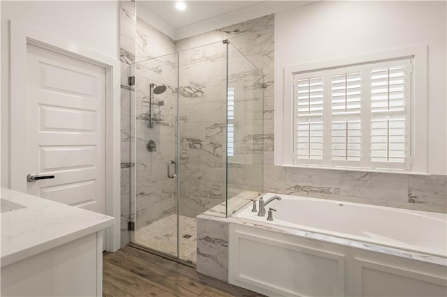 bathroom featuring shower with separate bathtub, vanity, and hardwood / wood-style flooring