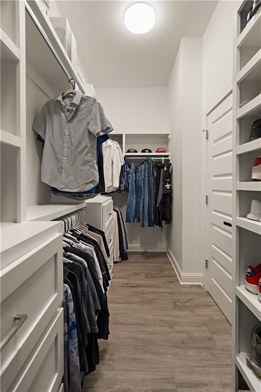 walk in closet featuring light hardwood / wood-style floors