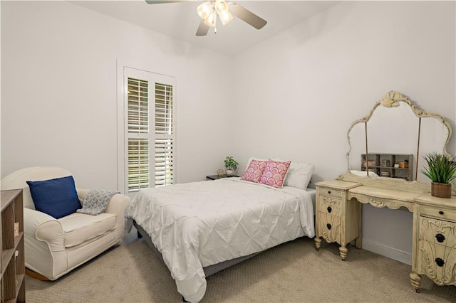 bedroom with ceiling fan and light colored carpet