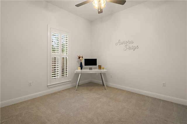 unfurnished office featuring light carpet and ceiling fan