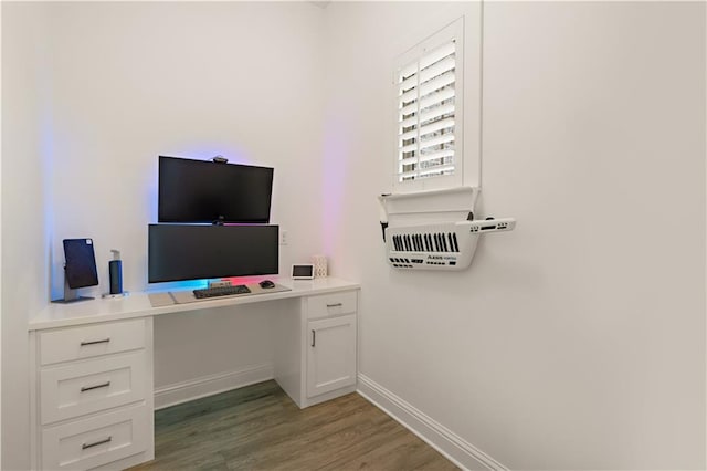 office featuring built in desk and light wood-type flooring