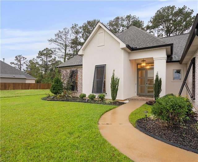 exterior space with a yard and french doors