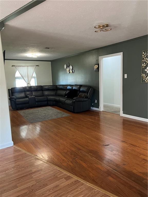 living room with wood-type flooring and a textured ceiling