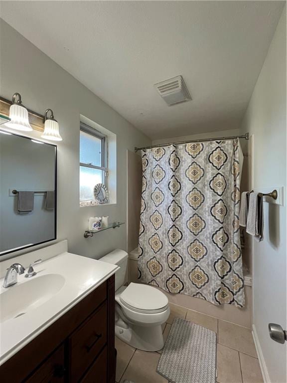 full bathroom featuring toilet, vanity, tile patterned floors, and shower / bath combo with shower curtain