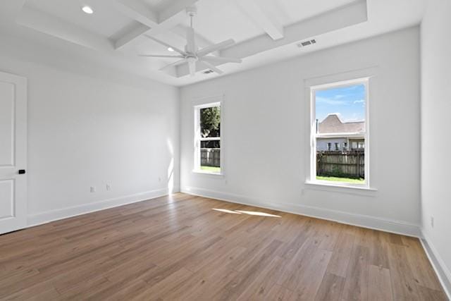 unfurnished room featuring beamed ceiling, light hardwood / wood-style floors, plenty of natural light, and ceiling fan