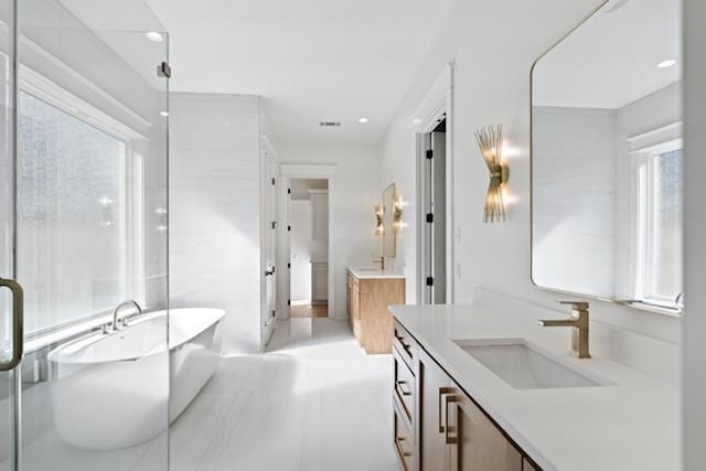 bathroom featuring vanity and a tub