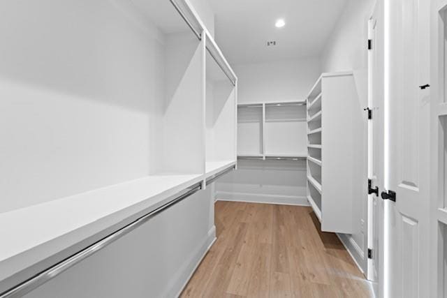 walk in closet featuring light hardwood / wood-style flooring