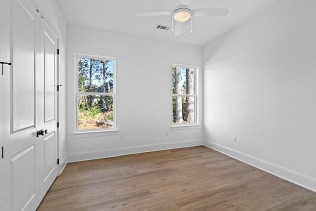 unfurnished room with light hardwood / wood-style flooring and ceiling fan