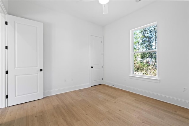 empty room featuring ceiling fan and light hardwood / wood-style flooring