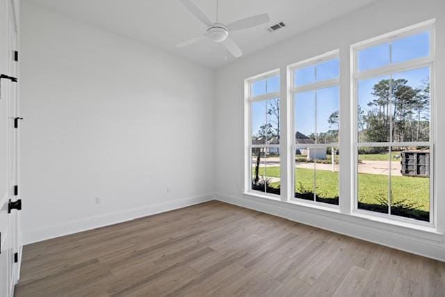 empty room featuring ceiling fan and wood-type flooring