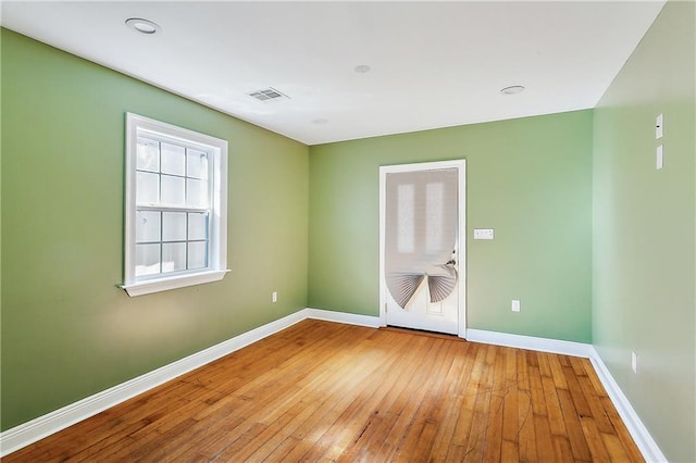 spare room with wood-type flooring