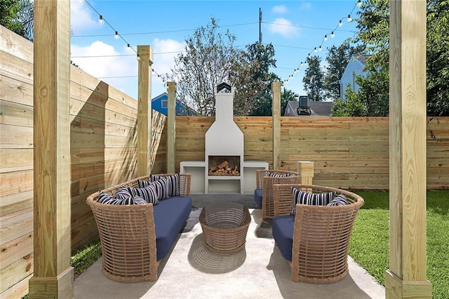 view of patio with an outdoor living space with a fireplace