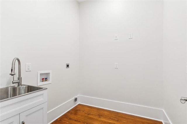 laundry area featuring cabinets, washer hookup, hookup for an electric dryer, sink, and hardwood / wood-style floors