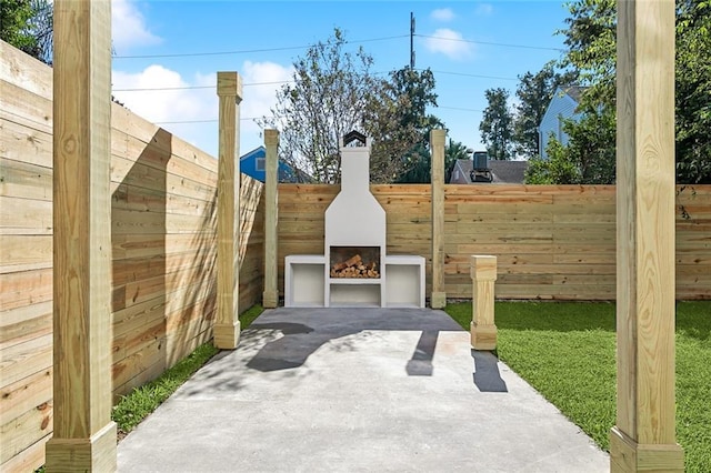 view of patio featuring exterior fireplace