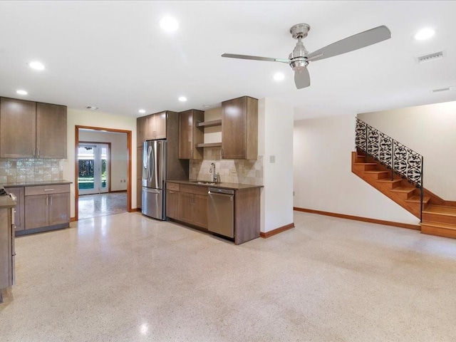 kitchen with ceiling fan, decorative backsplash, sink, and appliances with stainless steel finishes