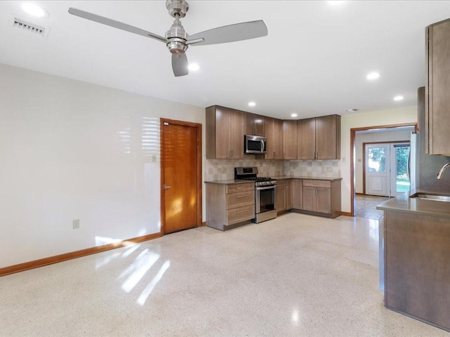 kitchen featuring tasteful backsplash, ceiling fan, sink, and stainless steel appliances