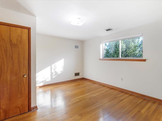 empty room with light hardwood / wood-style floors