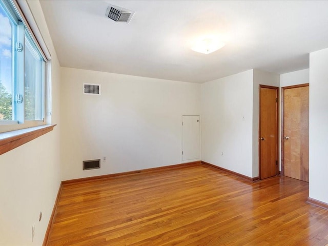 spare room with light wood-type flooring