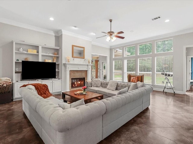 living room with crown molding, dark tile patterned floors, and ceiling fan