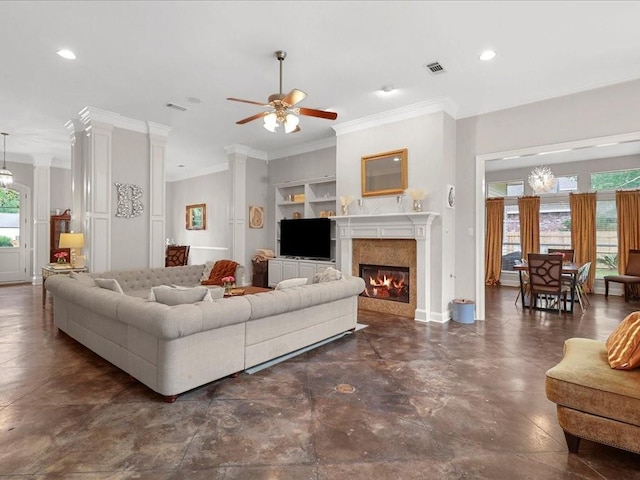 living room featuring built in shelves, ceiling fan, and crown molding