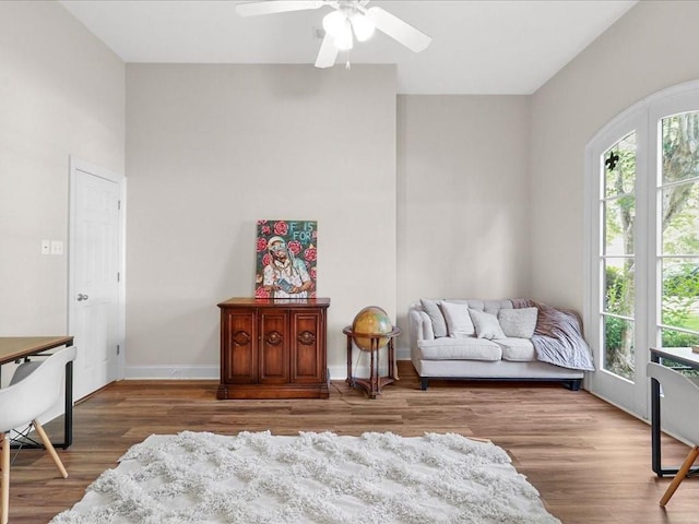 sitting room with hardwood / wood-style flooring and ceiling fan