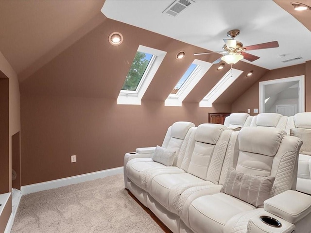 carpeted cinema room featuring ceiling fan and vaulted ceiling