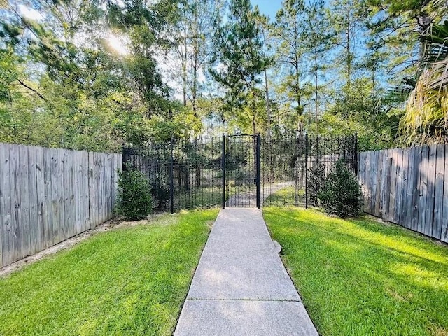 view of gate featuring a lawn