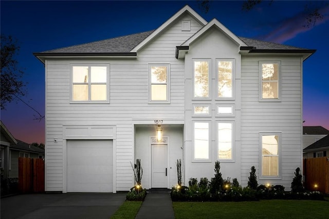 view of front of home featuring a garage and a yard