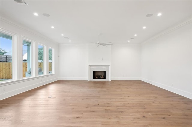 unfurnished living room with ceiling fan, light hardwood / wood-style floors, and ornamental molding