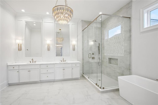 bathroom with separate shower and tub, vanity, and a notable chandelier