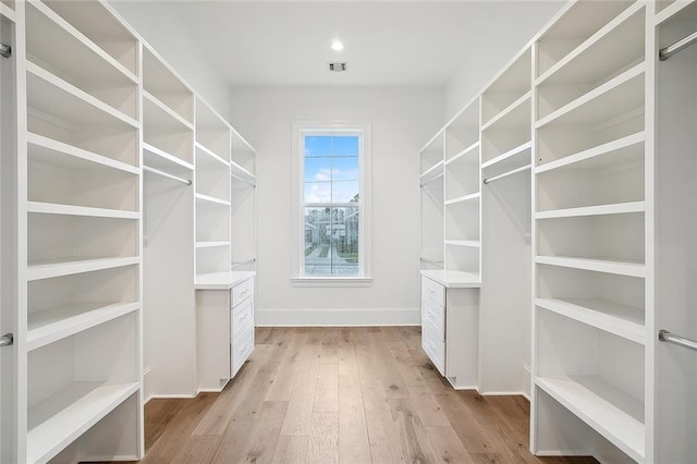 walk in closet featuring light hardwood / wood-style floors