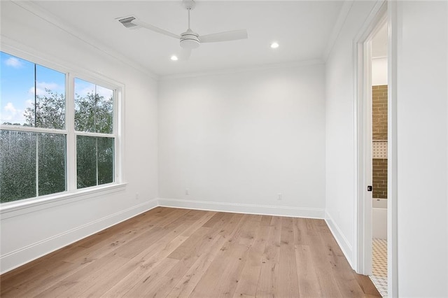 unfurnished room featuring ceiling fan, light wood-type flooring, and ornamental molding