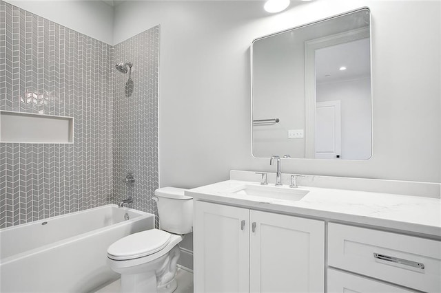 full bathroom featuring vanity, tiled shower / bath combo, and toilet