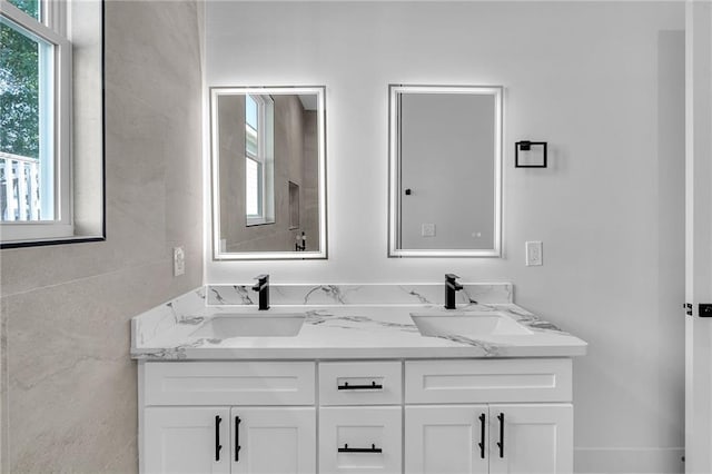 bathroom featuring vanity and tile walls