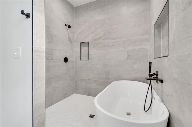 bathroom featuring shower with separate bathtub