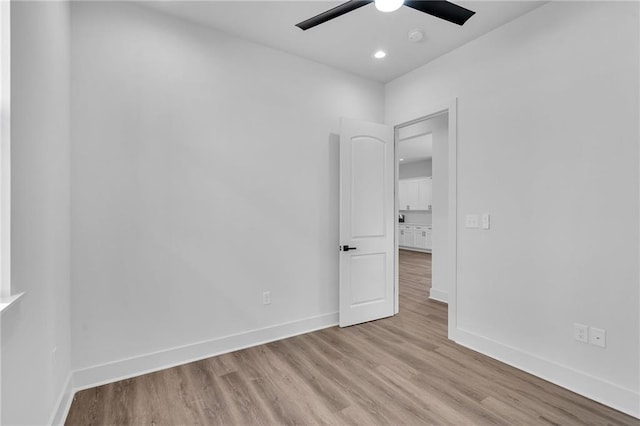 unfurnished room with light wood-type flooring and ceiling fan