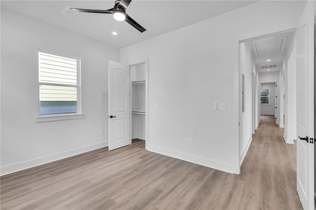 unfurnished bedroom featuring light wood-type flooring, a closet, and ceiling fan