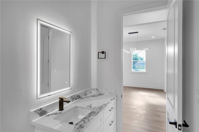 bathroom featuring a chandelier, vanity, and hardwood / wood-style flooring